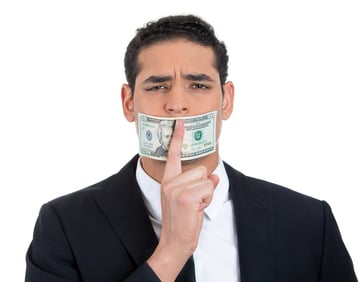 Closeup portrait of handsome corrupt guy in black suit with twenty dollar bill taped to mouth and showing shhh sign, isolated on white background. Bribery concept in politics, business, and diplomacy..jpeg