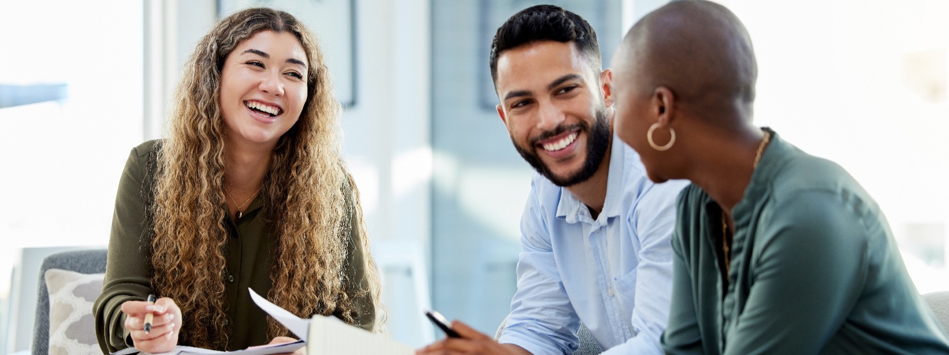 Three business people prepare before a negotiation.
