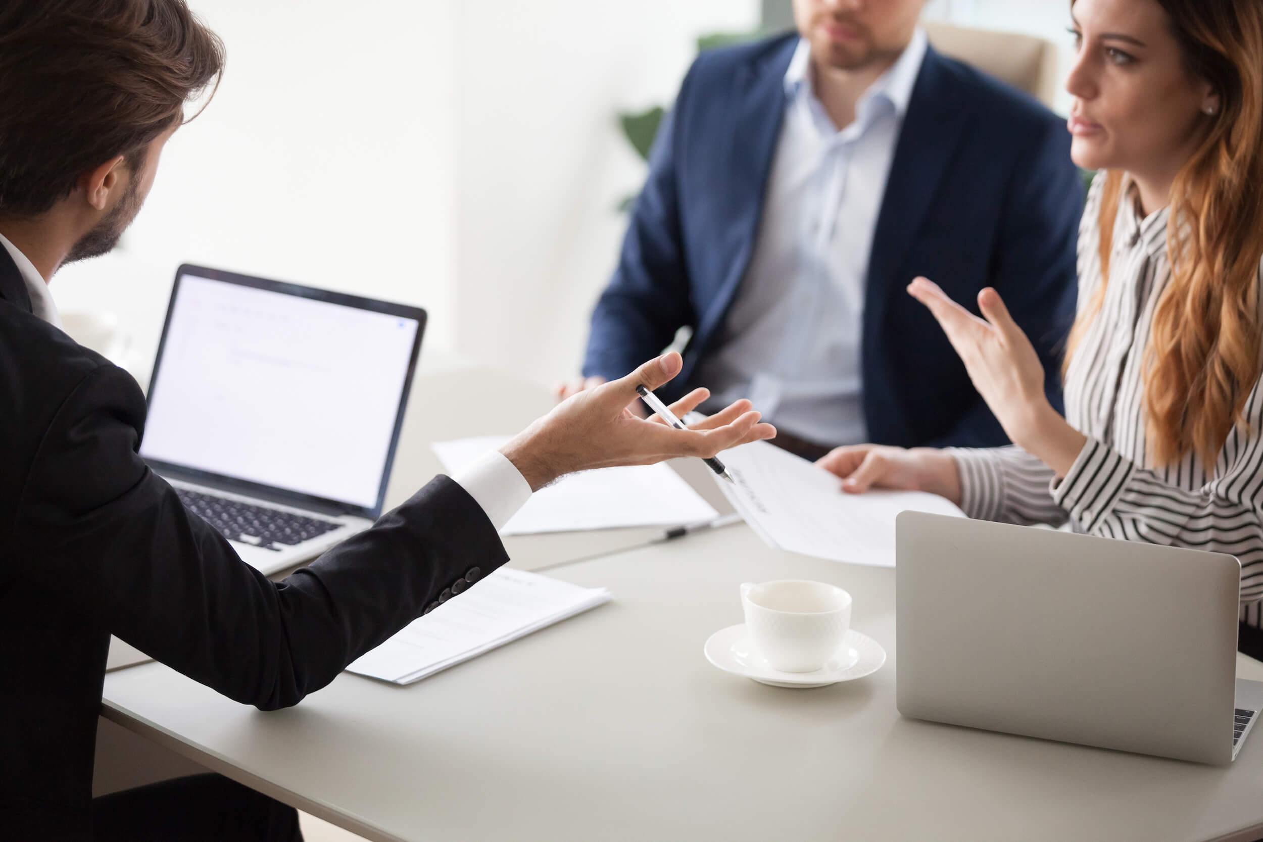 a businessman negotiating a contract with a female counterpart 