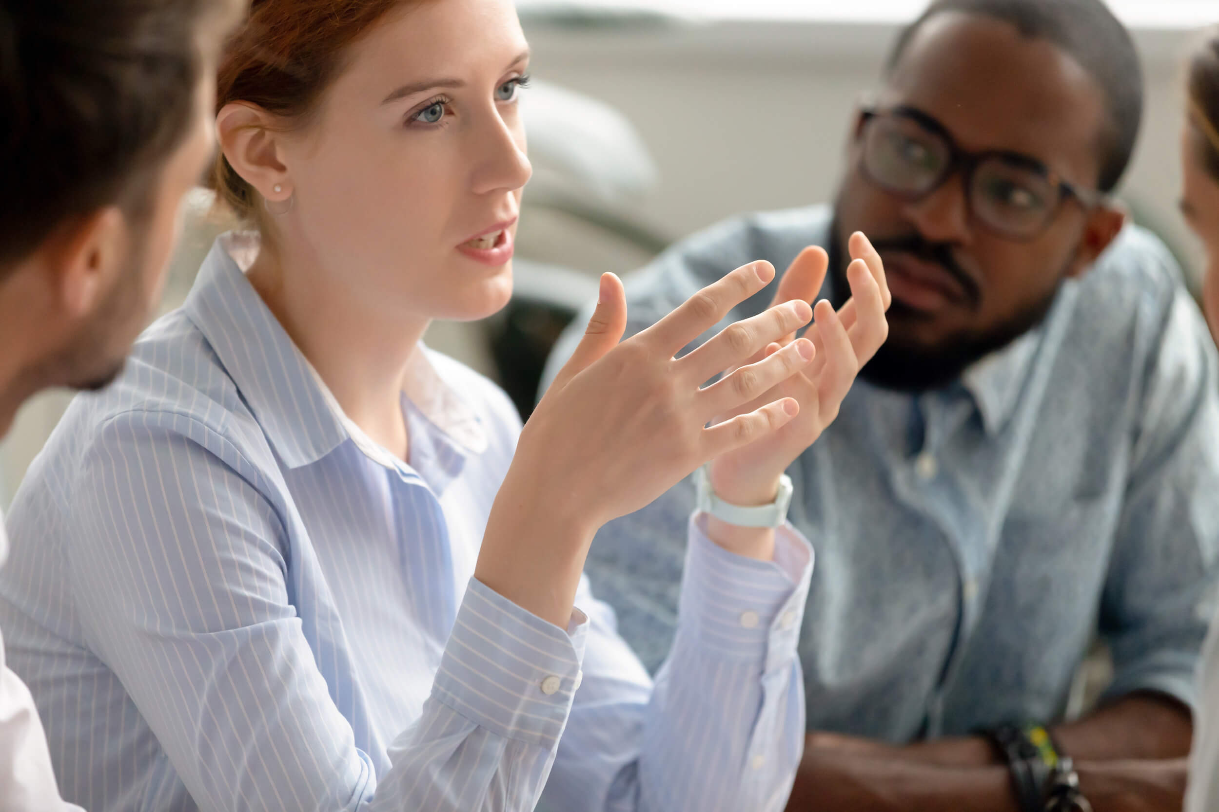 woman negotiating contract with group of business people