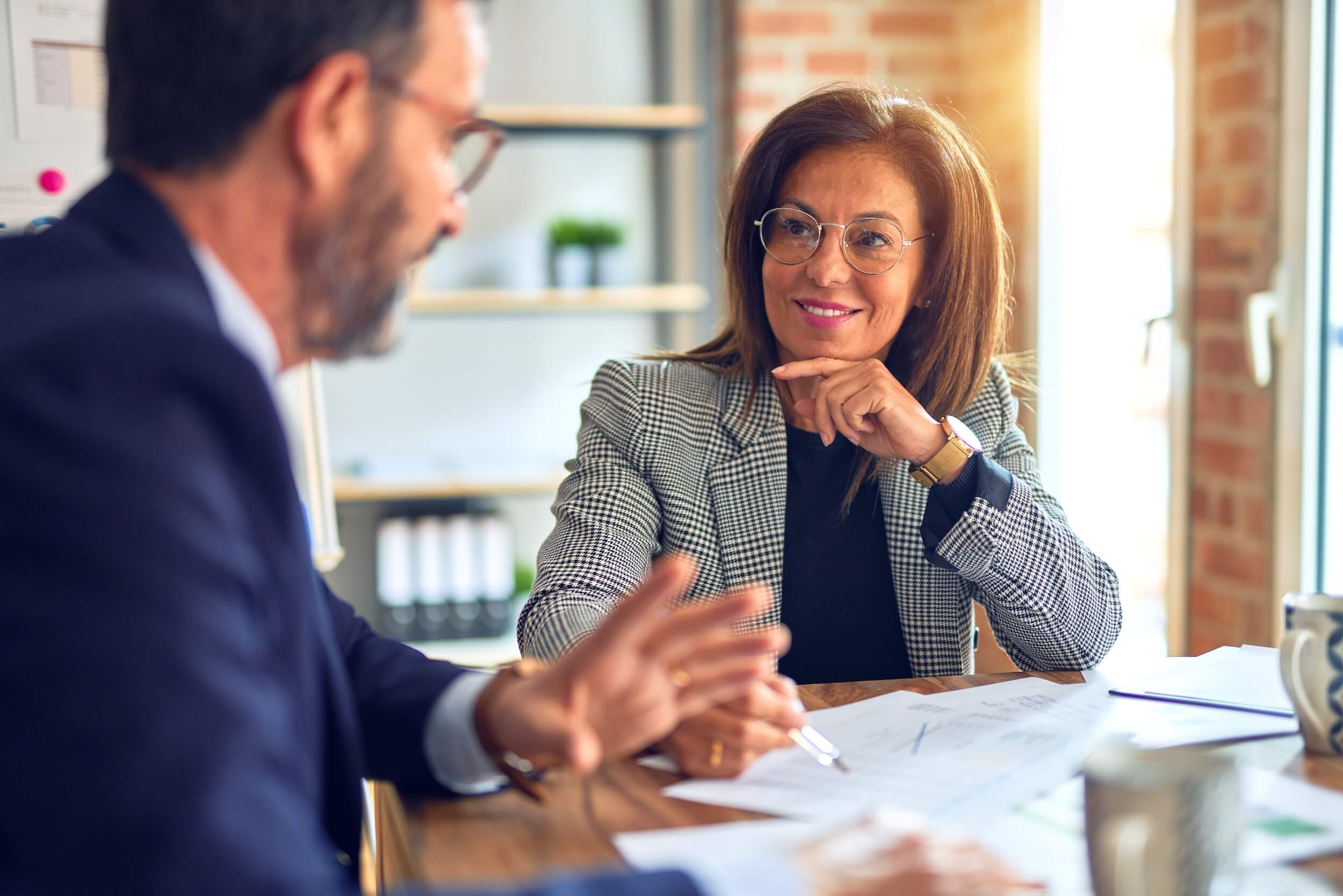 A woman listening while someone else is talking.