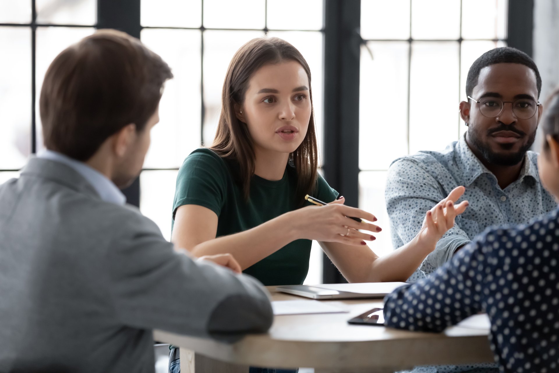 A business woman negotiates price with several counterparts.