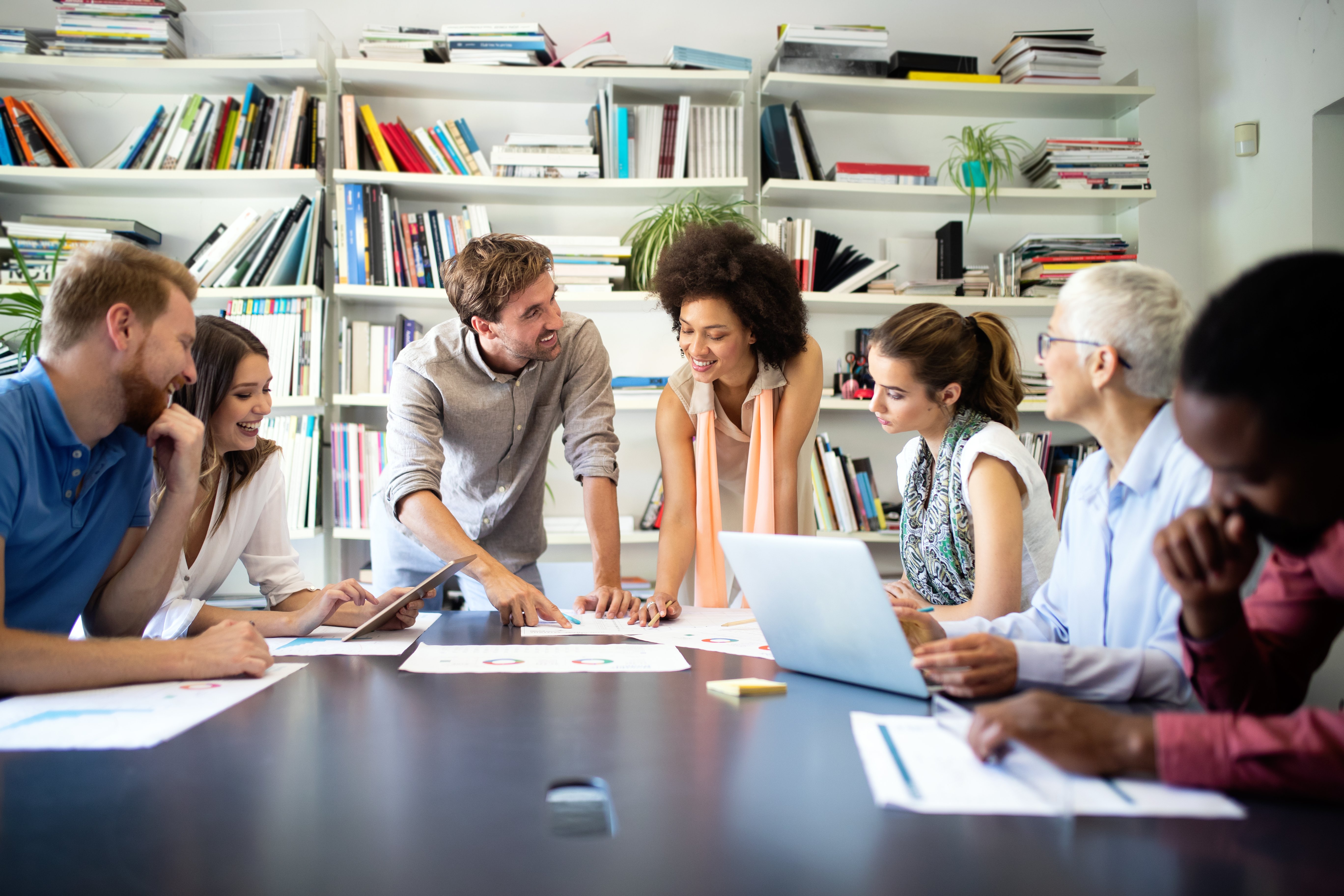 team of employees reviewing plan with leadership