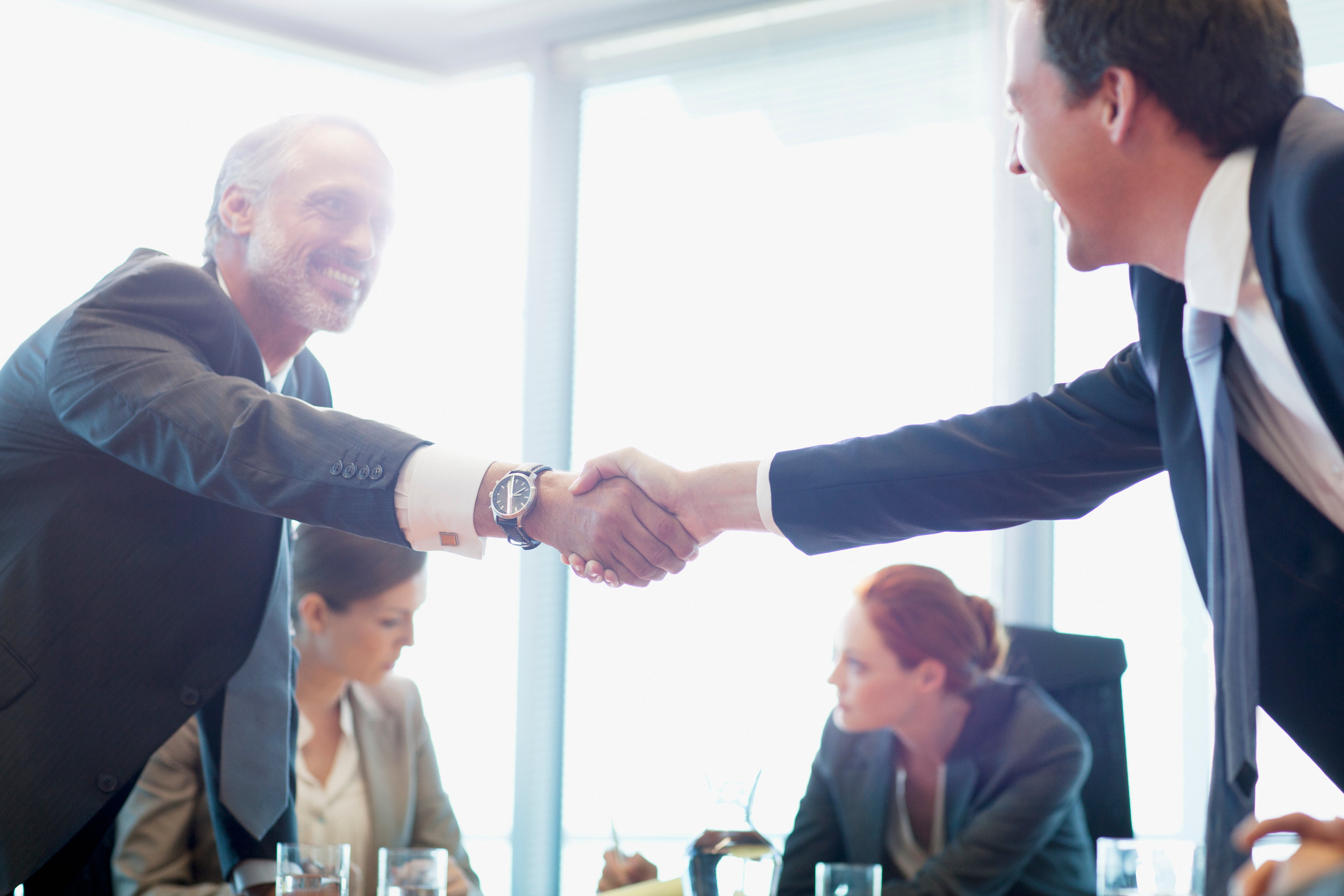 two men shaking hands after a negotiation