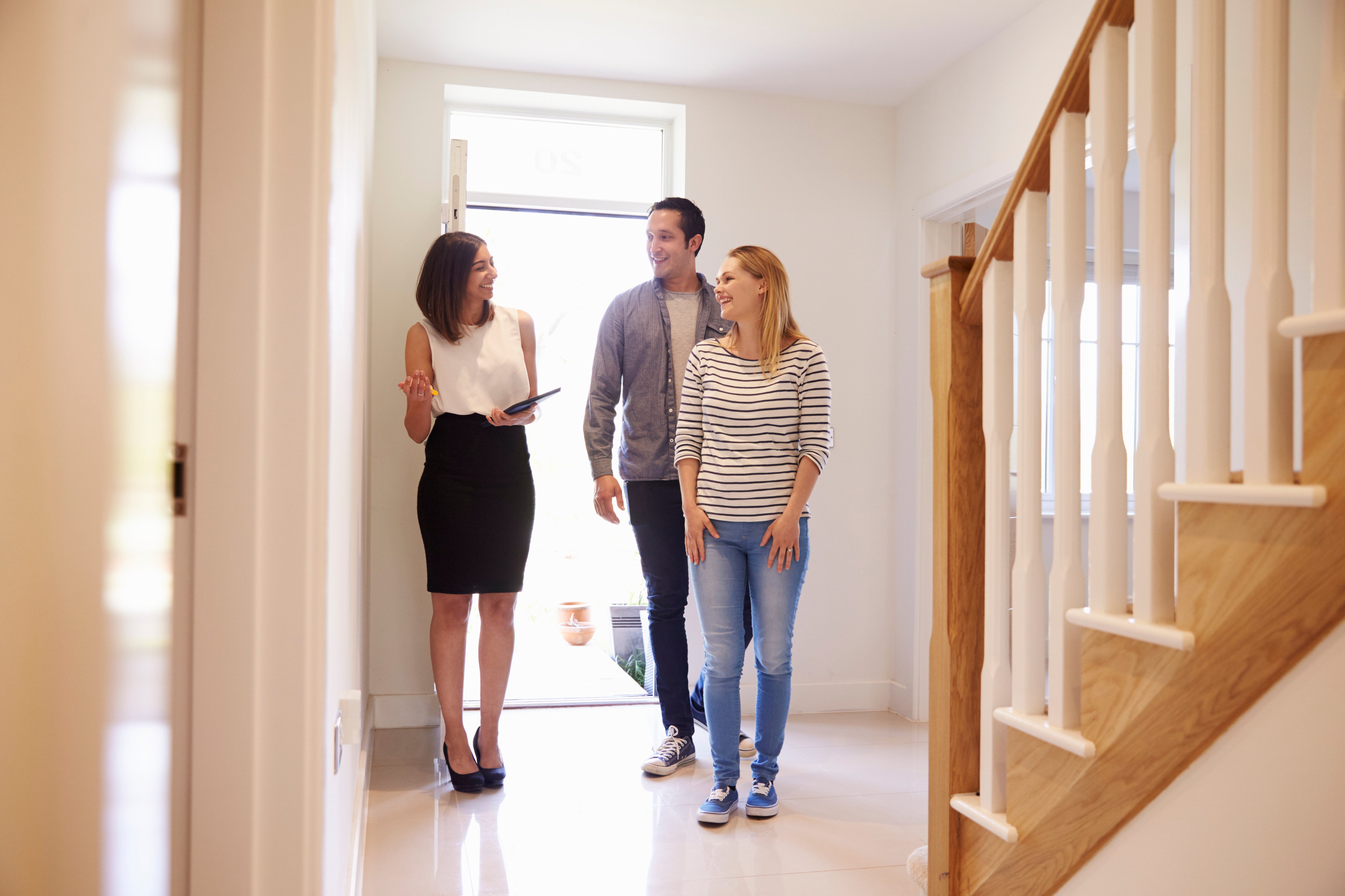 realtor showing real estate to prospective buyers